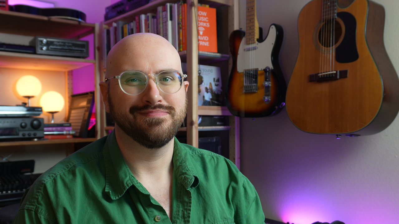 image of me sitting at my desk, smiling at the camera