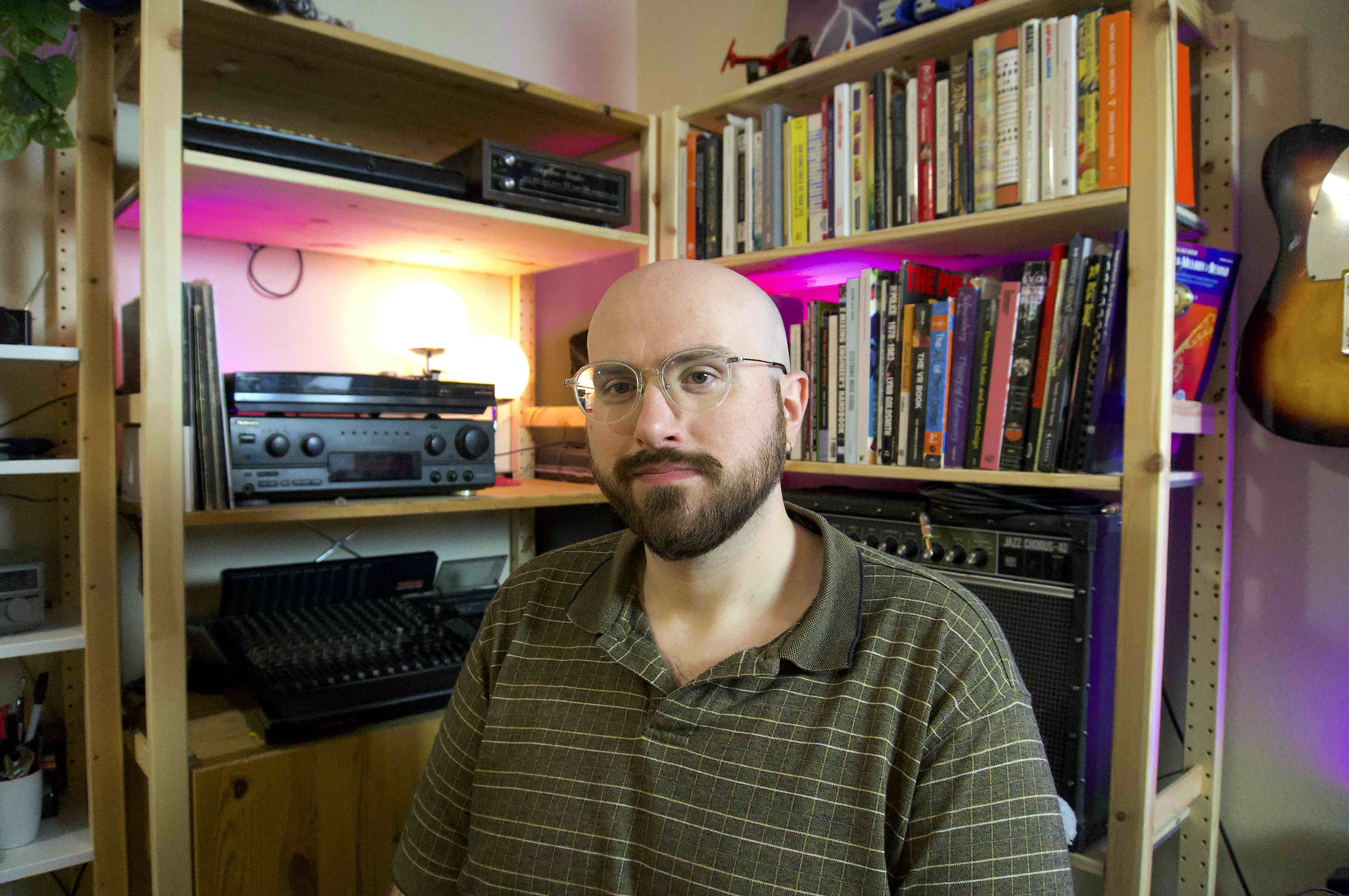 Image of me sitting in front of my bookshelf