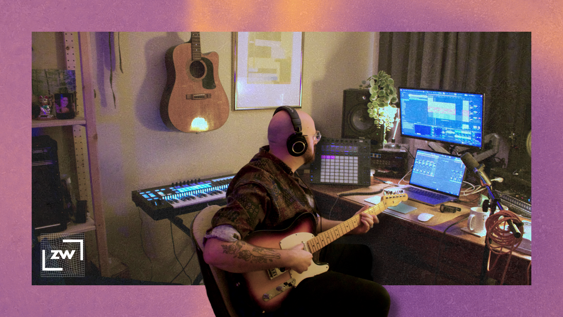 Image of me sitting at my desk playing guitar while looking at Ableton Live